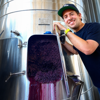 Mauricio Ruiz Cantú junto a un tanque de fermentación durante la elaboración de vino