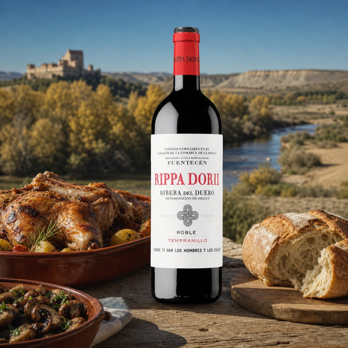 Botella de Rippa Dorii Roble sobre una mesa castellana con cordero y pan frente al paisaje de Ribera del Duero